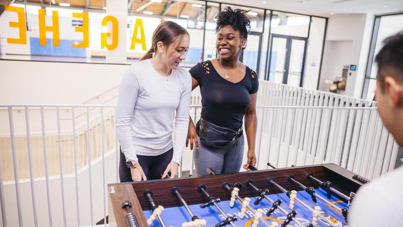 Students playing fooz ball at the CARW